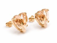 Side view of a gold plated heart crystal stud earring made with Swarovski Crystals, showing the faceted heart shape, prong setting and sparkling champagne crystal.