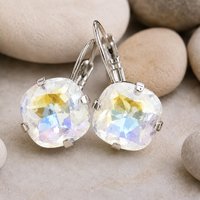 Sparkling Crystal cushion earrings displayed on a neutral stone background.