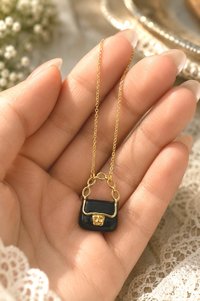 Fashion gift necklace featuring a miniature purse charm.