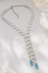 Sparkling Y lariat necklace with large clear faceted swarovski Rivoli crystals displayed on a white surface.