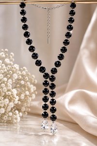 Swarovski Jet black and clear statement jewelry displayed hanging, showing the long Y shape and silver plated cupchain setting