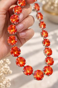 large 12mm swarovski Orange Ignite Rivoli crystals showing their vivid fiery orange sparkle.