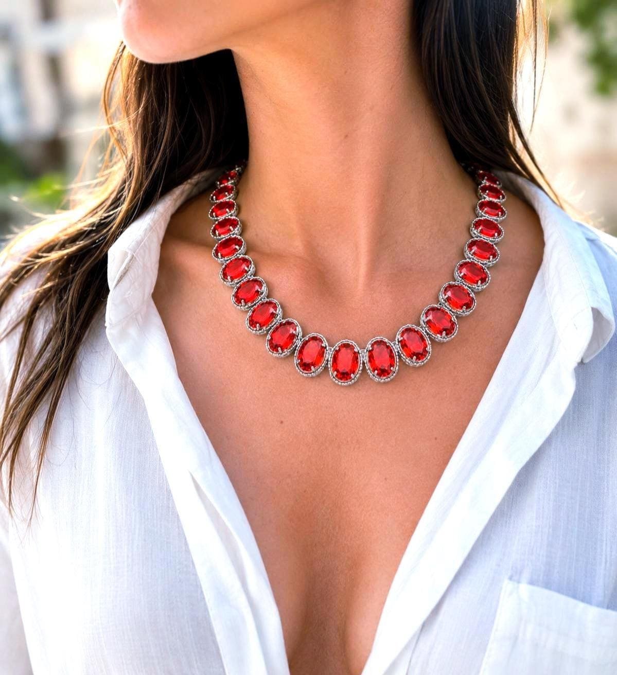 Vintage inspired red crystal statement necklace featuring oversized oval rhinestones in ornate platinum settings with elegant Art Deco style details