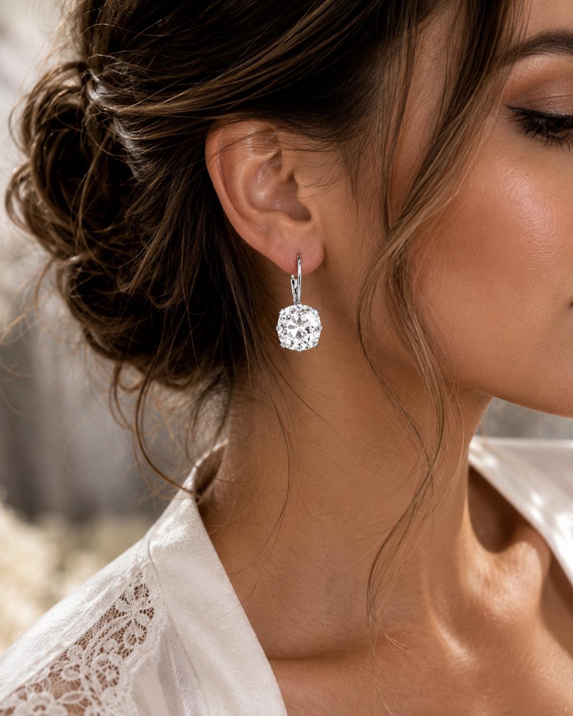 Handmade silver plated leverback earrings featuring 12mm clear Swarovski cushion cut crystals for vintage weddings and bridal wear.
