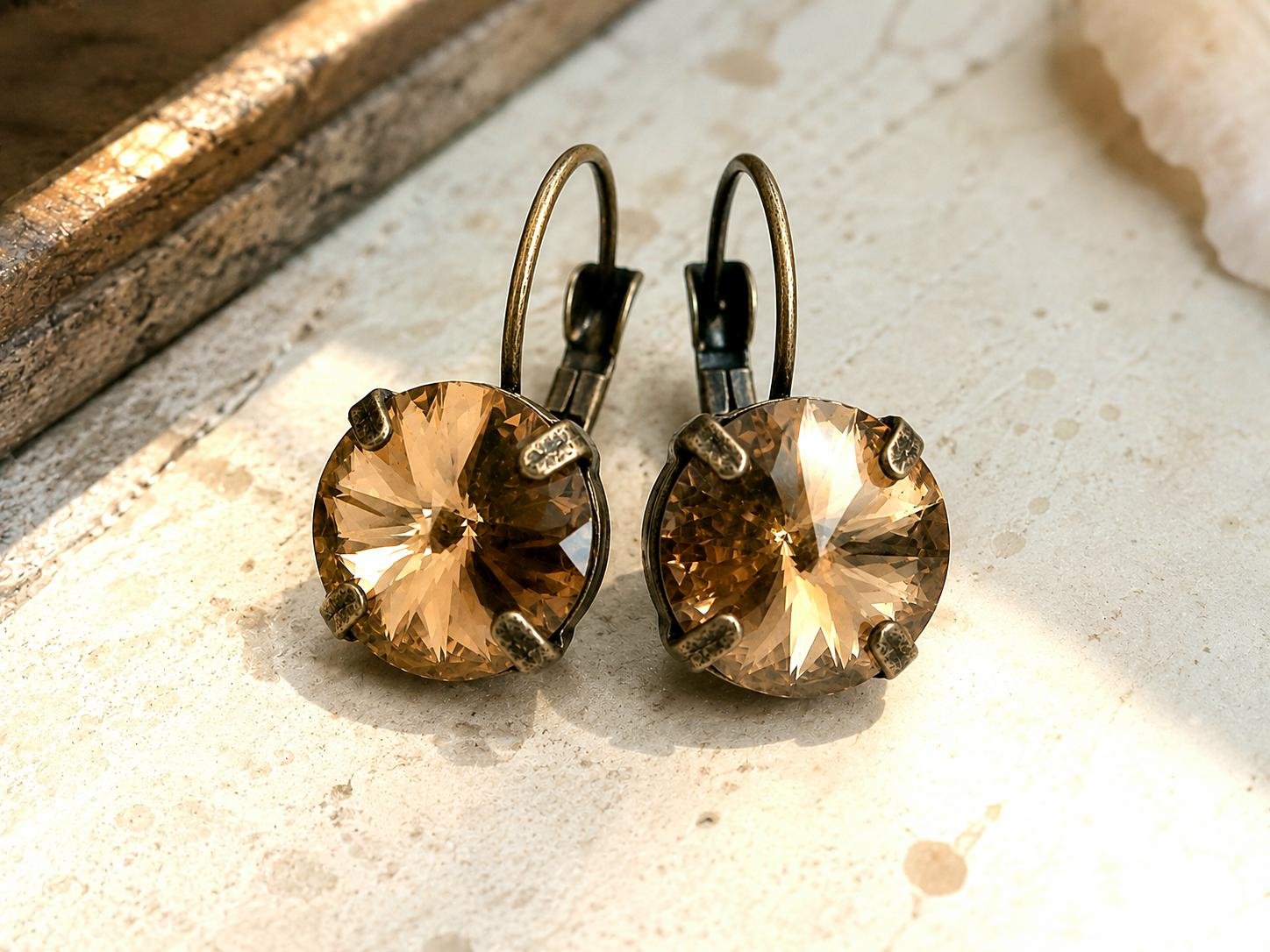 Sparkling metallic copper crystal earrings in antique bronze settings photographed on a neutral background.