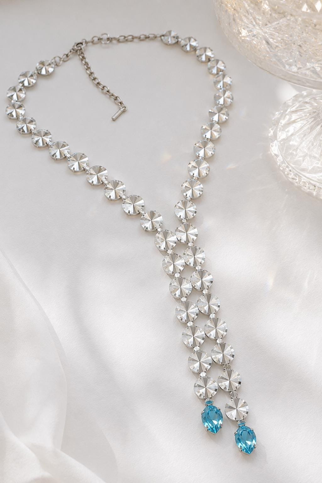 Sparkling Y lariat necklace with large clear faceted swarovski Rivoli crystals displayed on a white surface.
