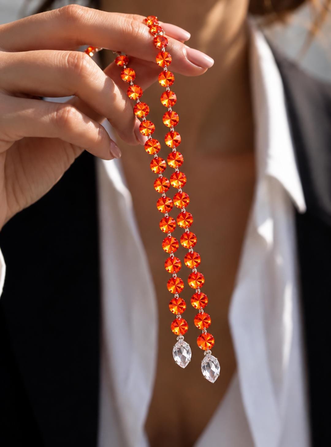 Close-up of 12mm Swarovski orange Rivoli crystals in a sparkling Y-style necklace