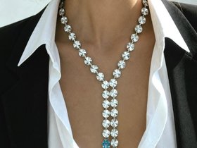 Swarovski Clear Rivoli crystal statement necklace worn with an open white shirt and black blazer.